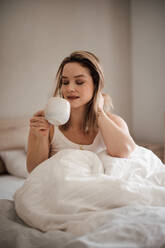 Portrait of young woman at morning in a bed. - HPIF35252