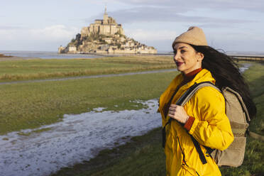 Traveler with backpack standing by Saint Michel castle on weekend - JCCMF10976