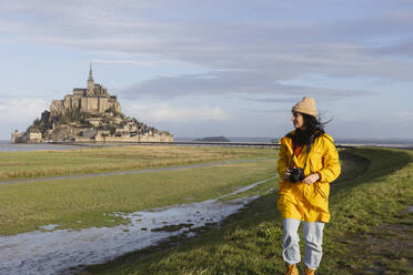 Traveler with camera exploring by Saint Michel castle on weekend - JCCMF10978