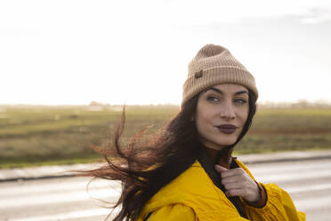 Beautiful woman with knit hat in front of sky - JCCMF10980