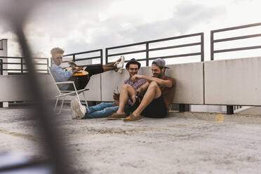 Carefree friends having party with beer on terrace - UUF30751