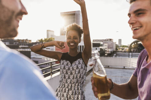 Carefree friends having party on rooftop - UUF30776