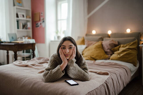 Young teenage girl with smartphone in a room. - HPIF35303