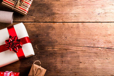 Christmas presents laid on a wooden table background - HPIF35661