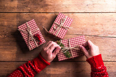 Christmas presents laid on a wooden table background - HPIF35670