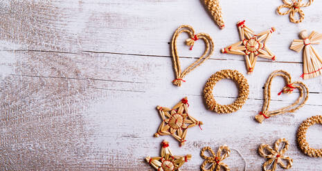 Christmas straw decoration. Studio shot on white wooden background. - HPIF35735