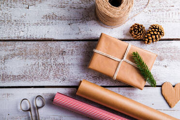 Christmas presents laid on a wooden table background - HPIF35741