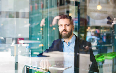 Double exposure of a handsome young man with tablet - HPIF35841