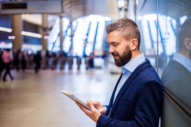 Young handsome businessman with tablet in subway - HPIF35887