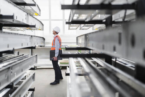 Engineer examining machinery in factory - DIGF21027