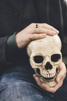 Man holding human skull - SVCF00418