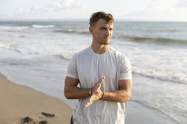 Man standing near sea at sunset - STF00012