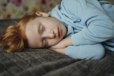 Redhead girl sleeping on bed - ANAF02570