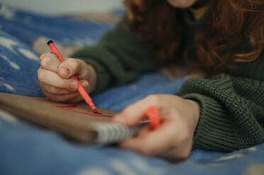 Girl drawing on book at home - ANAF02582