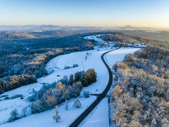 Germany, Baden-Wurttemberg, Aerial view of road in snow-covered Remstal valley - STSF03803