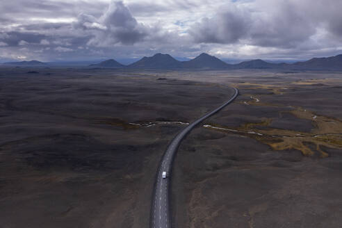 Iceland, Austurland, Aerial view of lone truck driving along Route 1 - RUEF04275