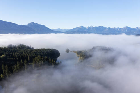 Germany, Bavaria, Aerial view of Illasbergsee and Forggensee lakes shrouded in thick fog - RUEF04276