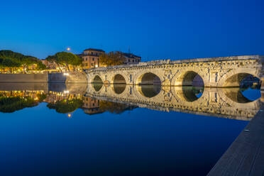 View of Ponte di Tiberio reflecting in Rimini Canal in Borgo San Giuliano district at dusk, Rimini, Emilia-Romagna, Italy, Europe - RHPLF29974