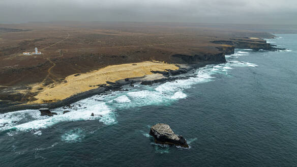 Aerial of the wild coastline with basalt pools on the Atlantic coastline, Dombe Grande, Namibre, Angola, Africa - RHPLF30438