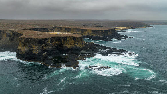 Aerial of the wild coastline with basalt pools on the Atlantic coastline, Dombe Grande, Namibre, Angola, Africa - RHPLF30439