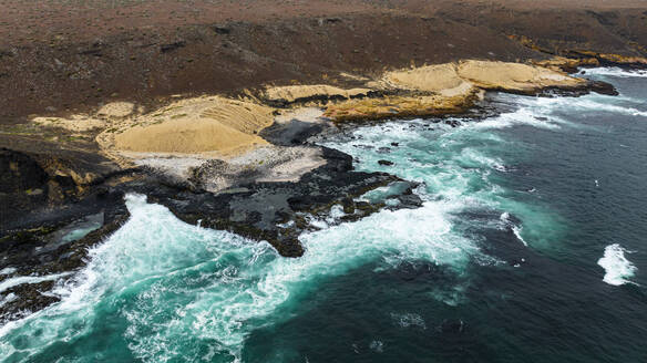 Aerial of the wild coastline with basalt pools on the Atlantic coastline, Dombe Grande, Namibre, Angola, Africa - RHPLF30442