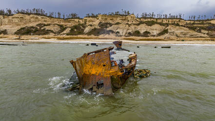 Männer zerlegen ein Boot am Strand von Shipwreck, Bucht von Santiago, Luanda, Angola, Afrika - RHPLF30553