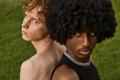 Young gay couple with curly hair in front of grass - SECF00046