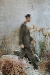 Young businessman walking in garden - YTF01531