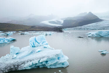 Die ruhige Kulisse einer Gletscherlagune mit schwimmenden Eisbergen inmitten des Vatnajokull-Nationalparks zeigt die natürliche Schönheit der isländischen Landschaften. - ADSF50672