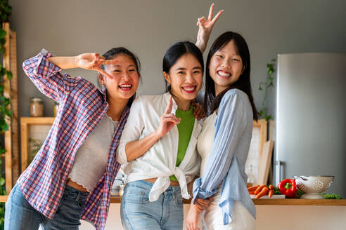 Happy beautiful chinese women friends bonding at home - Playful pretty asian female adults meeting and having fun at home, concepts about lifestyle, domestic life and friendship - DMDF07978