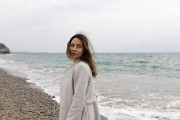 Young woman walking near sea at beach - MMPF01101