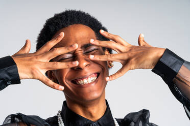 Fluid gender hispanic latin black man posing in studio with fashionable clothing, concepts about LGBTQ, genderless and diversity - DMDF08141