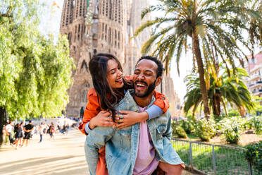 Multirassisches glückliches Liebespaar an der Sagrada Familia, Barcelona - Multiethnische Touristen, die in Europa reisen und eine Stadt in Spanien besuchen, Konzepte über Tourismus und Lebensstil der Menschen - DMDF08182