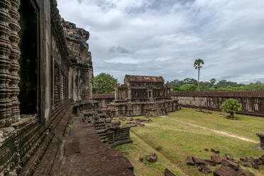 Mysterious ruins of the Angkor Wat complex standing still against time and nature, showcasing the splendor of the ancient Khmer civilization. - ADSF50815