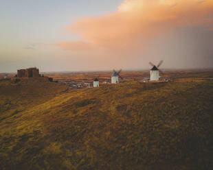 Aerial view of the old windmills on top of Consuegra at sunset, Castilla la Mancha, Spain. - AAEF24847