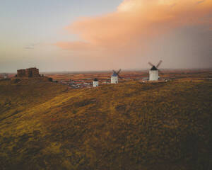 Aerial view of the old windmills on top of Consuegra at sunset, Castilla la Mancha, Spain. - AAEF24847