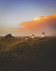 Aerial view of the old windmills on top of Consuegra at sunset, Castilla la Mancha, Spain. - AAEF24848