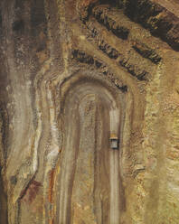 Aerial topdown shot of mine vehicles, in Minas de Rio Tinto, Andalusia, Spain. - AAEF24856