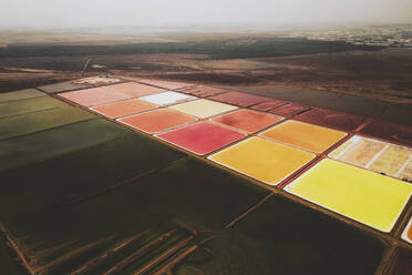 Aerial view of colourful Salinas, salt lakes pool at Farm colony la Algaida, Andalusia, Spain. - AAEF24885