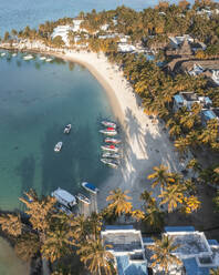 Aerial view of small boats along a white sand beach with a luxury resort along the coast, Grand Port, Mauritius. - AAEF25087