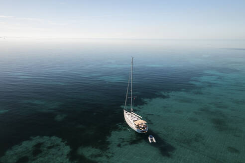 Aerial view of a sail boat on the shallow water of the Berry Islands, the Bahamas. - AAEF25123