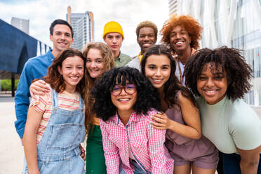 Happy playful multiethnic group of young friends bonding outdoors - Multiracial millennials students meeting in the city, concepts of youth, people lifestyle, diversity, teenage and urban life - DMDF08826