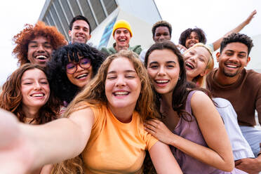 Happy playful multiethnic group of young friends bonding outdoors - Multiracial millennials students meeting in the city, concepts of youth, people lifestyle, diversity, teenage and urban life - DMDF08881