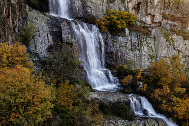 Majestic Despeñalagua Waterfall in Valverde de los Arroyos, Guadalajara, surrounded by autumn foliage. - ADSF50945