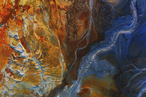 An aerial shot captures the dramatic and colorful terrain of Riotinto in Huelva, Spain, with its diverse mineral deposits and winding rivers creating a striking natural tapestry. - ADSF50949