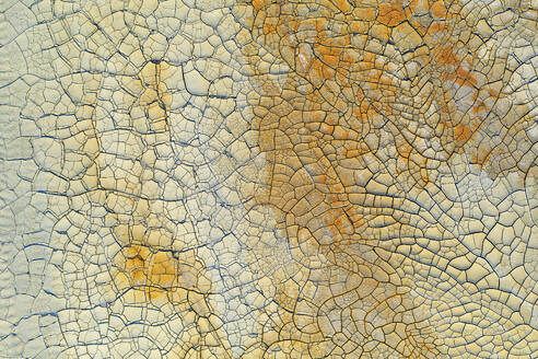 An aerial photograph capturing the intricate patterns of the cracked soil in Riotinto, with a palette of warm earthy tones. - ADSF50950