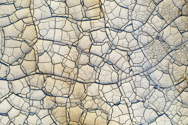 Overhead view of cracked soil in Riotinto, reflecting a natural arid landscape texture with distinct parched patterns. - ADSF50956