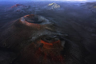 An aerial shot captures the dramatic volcanic landscape of Iceland, showcasing the rugged craters and contrasting colors - ADSF51057