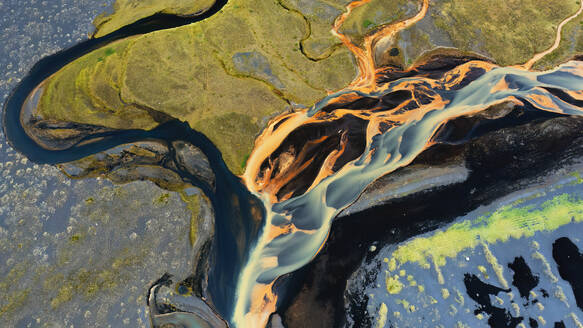 A stunning aerial shot capturing the meandering patterns of river basins in Iceland, with vivid colors and unique geological textures - ADSF51069