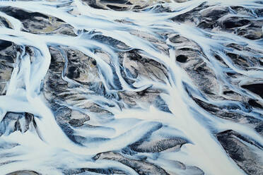 Intricate patterns of a river basin weave through the snow in this aerial shot over Iceland's rugged terrain - ADSF51087